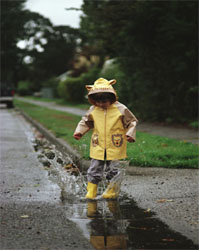 Child playing in the rain